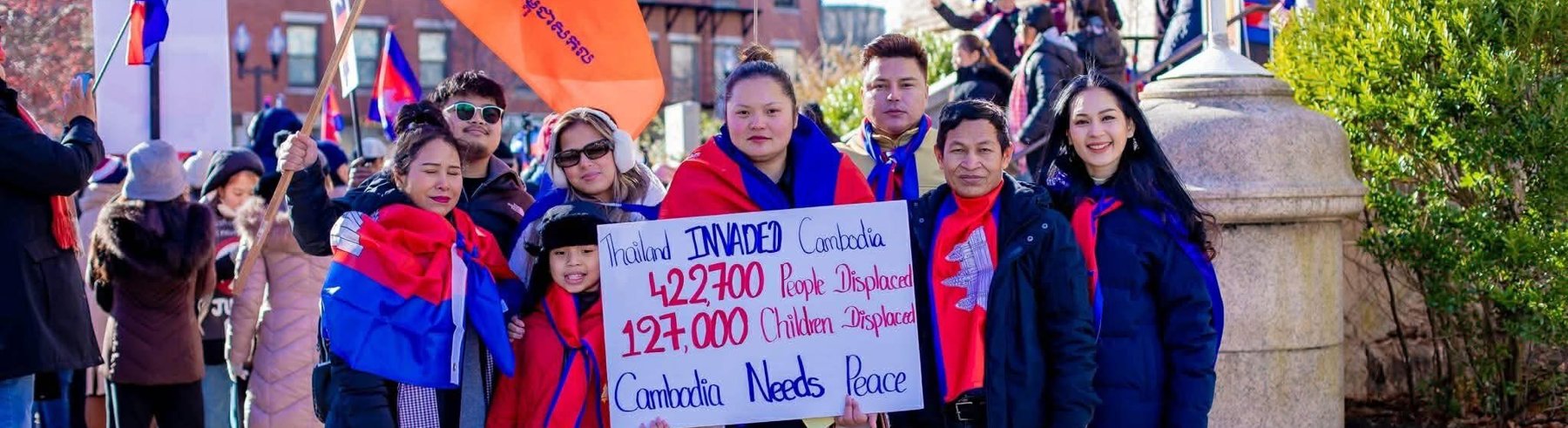 GCYN supporters holding Cambodian flags and a sign calling for peace